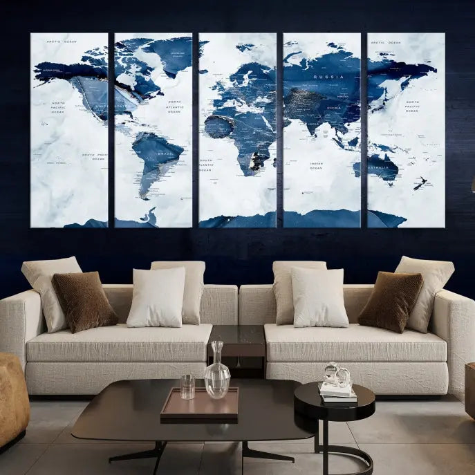 The Navy Blue World Map with Antarctica Wall Art Canvas Print, featuring a stunning blend of blue and white on a museum-quality canvas, elegantly adorns a dark wall. This ready-to-hang masterpiece enhances the room's sophisticated ambiance.