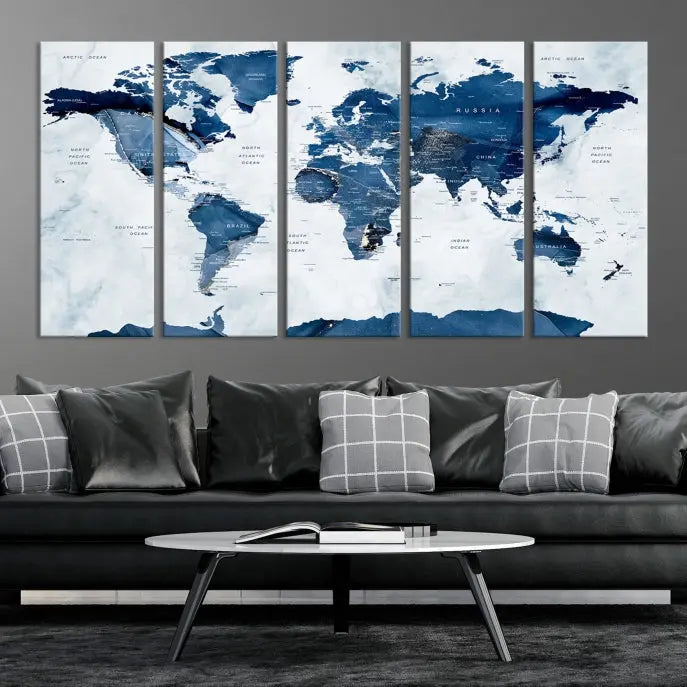 The Navy Blue World Map with Antarctica Wall Art Canvas Print, featuring a stunning blend of blue and white on a museum-quality canvas, elegantly adorns a dark wall. This ready-to-hang masterpiece enhances the room's sophisticated ambiance.