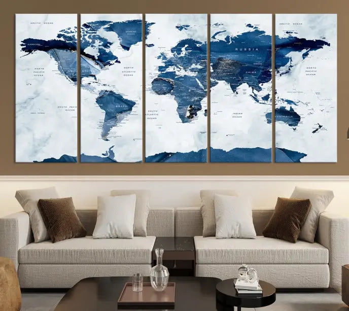 The Navy Blue World Map with Antarctica Wall Art Canvas Print, featuring a stunning blend of blue and white on a museum-quality canvas, elegantly adorns a dark wall. This ready-to-hang masterpiece enhances the room's sophisticated ambiance.