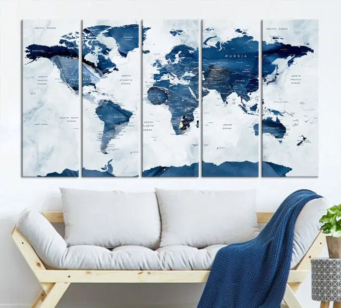 The Navy Blue World Map with Antarctica Wall Art Canvas Print, featuring a stunning blend of blue and white on a museum-quality canvas, elegantly adorns a dark wall. This ready-to-hang masterpiece enhances the room's sophisticated ambiance.