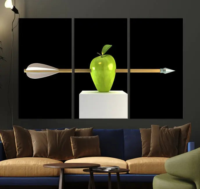 The "Apple and Arrow Wall Art Apple Illustr Canvas Print" is a triptych art piece depicting an arrow through a green apple on a black background. This gallery-wrapped artwork, printed on museum-quality canvas, ensures vibrancy and durability.