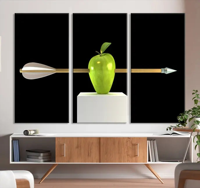 The "Apple and Arrow Wall Art Apple Illustr Canvas Print" is a triptych art piece depicting an arrow through a green apple on a black background. This gallery-wrapped artwork, printed on museum-quality canvas, ensures vibrancy and durability.