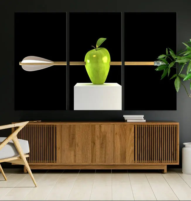 The "Apple and Arrow Wall Art Apple Illustr Canvas Print" is a triptych art piece depicting an arrow through a green apple on a black background. This gallery-wrapped artwork, printed on museum-quality canvas, ensures vibrancy and durability.