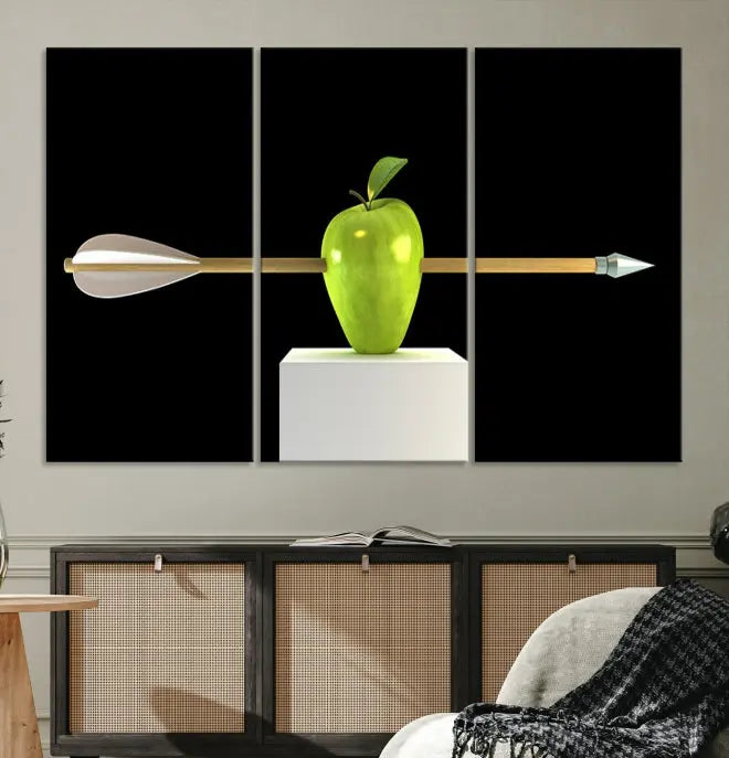 The "Apple and Arrow Wall Art Apple Illustr Canvas Print" is a triptych art piece depicting an arrow through a green apple on a black background. This gallery-wrapped artwork, printed on museum-quality canvas, ensures vibrancy and durability.