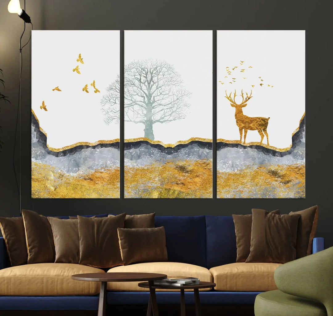 The dark gray wall is adorned with a triptych featuring a tree, birds, and a stag. This piece, titled "Artistic Deer Painting Wall Art Canvas Print Animal Wall Art Deer Art Print," is crafted as gallery-wrapped art from museum-quality polycotton and features a UV-protective coating to preserve its vibrant display.