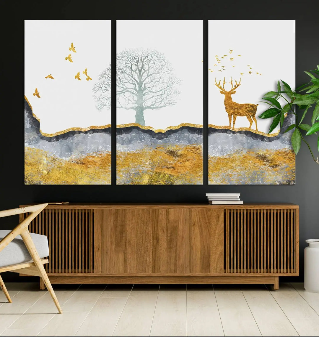 The dark gray wall is adorned with a triptych featuring a tree, birds, and a stag. This piece, titled "Artistic Deer Painting Wall Art Canvas Print Animal Wall Art Deer Art Print," is crafted as gallery-wrapped art from museum-quality polycotton and features a UV-protective coating to preserve its vibrant display.