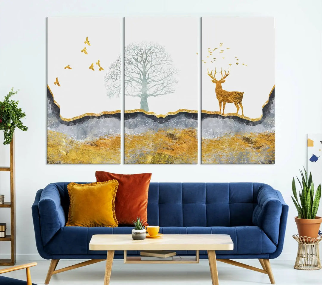 The dark gray wall is adorned with a triptych featuring a tree, birds, and a stag. This piece, titled "Artistic Deer Painting Wall Art Canvas Print Animal Wall Art Deer Art Print," is crafted as gallery-wrapped art from museum-quality polycotton and features a UV-protective coating to preserve its vibrant display.