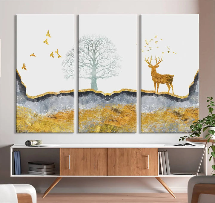 The dark gray wall is adorned with a triptych featuring a tree, birds, and a stag. This piece, titled "Artistic Deer Painting Wall Art Canvas Print Animal Wall Art Deer Art Print," is crafted as gallery-wrapped art from museum-quality polycotton and features a UV-protective coating to preserve its vibrant display.