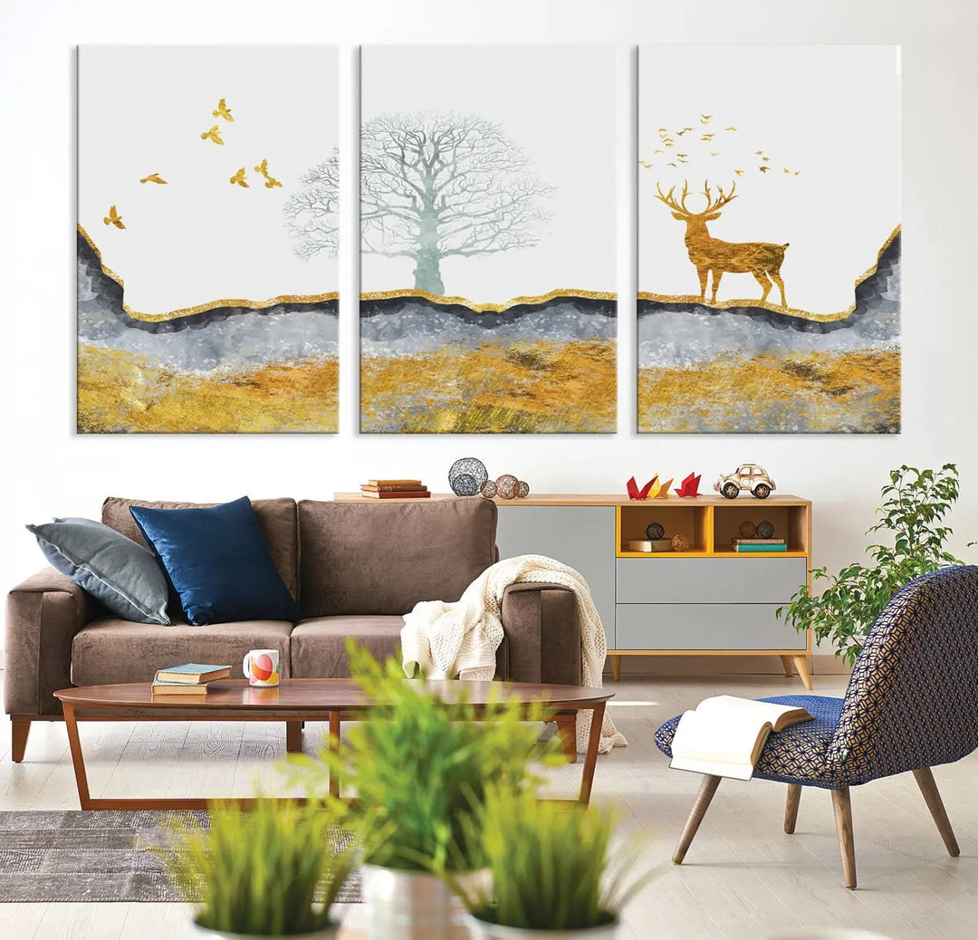 The dark gray wall is adorned with a triptych featuring a tree, birds, and a stag. This piece, titled "Artistic Deer Painting Wall Art Canvas Print Animal Wall Art Deer Art Print," is crafted as gallery-wrapped art from museum-quality polycotton and features a UV-protective coating to preserve its vibrant display.