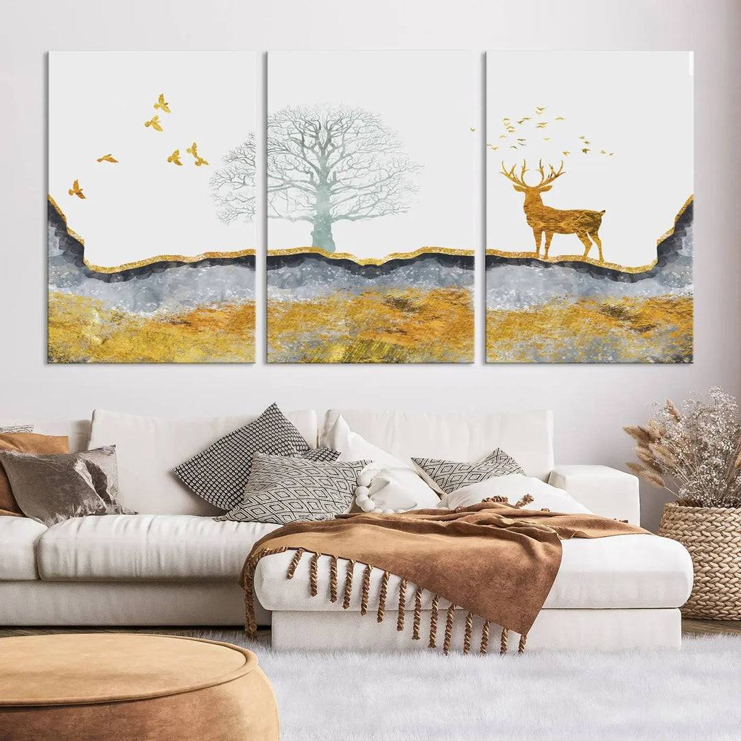 The dark gray wall is adorned with a triptych featuring a tree, birds, and a stag. This piece, titled "Artistic Deer Painting Wall Art Canvas Print Animal Wall Art Deer Art Print," is crafted as gallery-wrapped art from museum-quality polycotton and features a UV-protective coating to preserve its vibrant display.