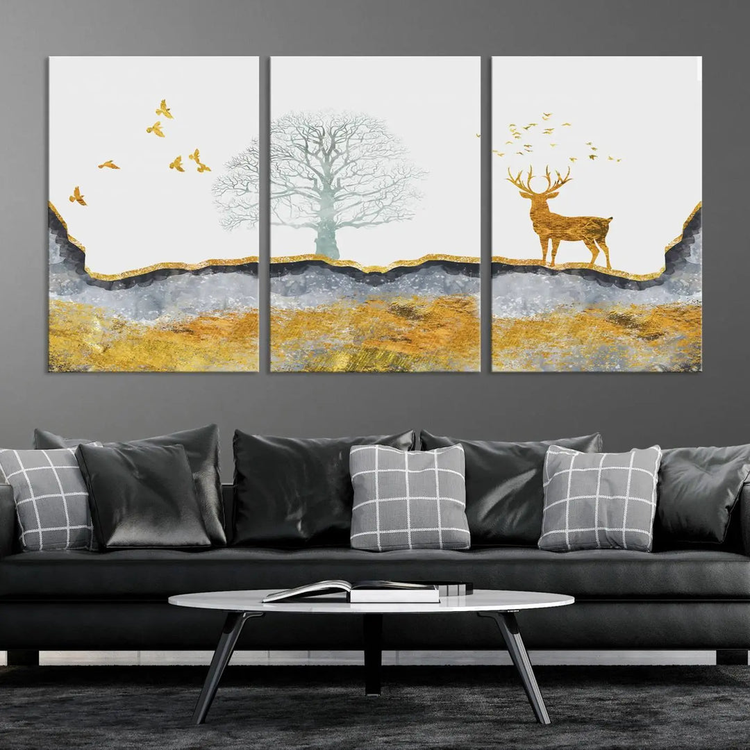 The dark gray wall is adorned with a triptych featuring a tree, birds, and a stag. This piece, titled "Artistic Deer Painting Wall Art Canvas Print Animal Wall Art Deer Art Print," is crafted as gallery-wrapped art from museum-quality polycotton and features a UV-protective coating to preserve its vibrant display.