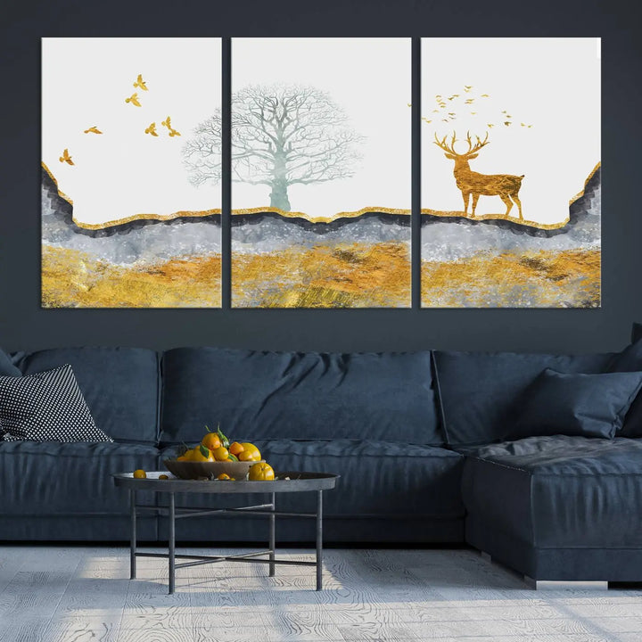 The dark gray wall is adorned with a triptych featuring a tree, birds, and a stag. This piece, titled "Artistic Deer Painting Wall Art Canvas Print Animal Wall Art Deer Art Print," is crafted as gallery-wrapped art from museum-quality polycotton and features a UV-protective coating to preserve its vibrant display.