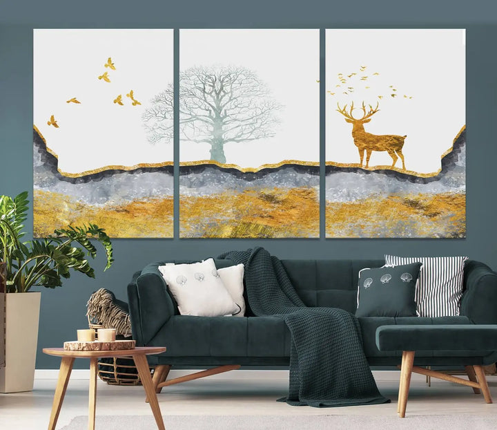 The dark gray wall is adorned with a triptych featuring a tree, birds, and a stag. This piece, titled "Artistic Deer Painting Wall Art Canvas Print Animal Wall Art Deer Art Print," is crafted as gallery-wrapped art from museum-quality polycotton and features a UV-protective coating to preserve its vibrant display.