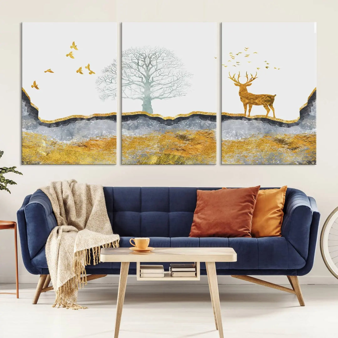 The dark gray wall is adorned with a triptych featuring a tree, birds, and a stag. This piece, titled "Artistic Deer Painting Wall Art Canvas Print Animal Wall Art Deer Art Print," is crafted as gallery-wrapped art from museum-quality polycotton and features a UV-protective coating to preserve its vibrant display.