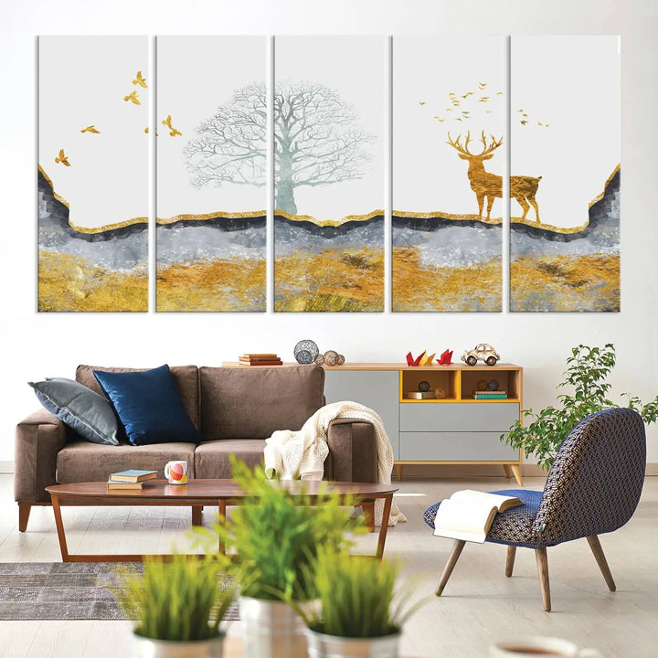 The dark gray wall is adorned with a triptych featuring a tree, birds, and a stag. This piece, titled "Artistic Deer Painting Wall Art Canvas Print Animal Wall Art Deer Art Print," is crafted as gallery-wrapped art from museum-quality polycotton and features a UV-protective coating to preserve its vibrant display.