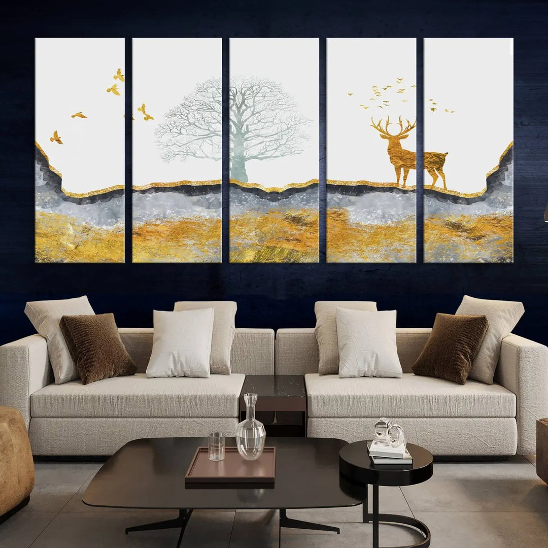 The dark gray wall is adorned with a triptych featuring a tree, birds, and a stag. This piece, titled "Artistic Deer Painting Wall Art Canvas Print Animal Wall Art Deer Art Print," is crafted as gallery-wrapped art from museum-quality polycotton and features a UV-protective coating to preserve its vibrant display.