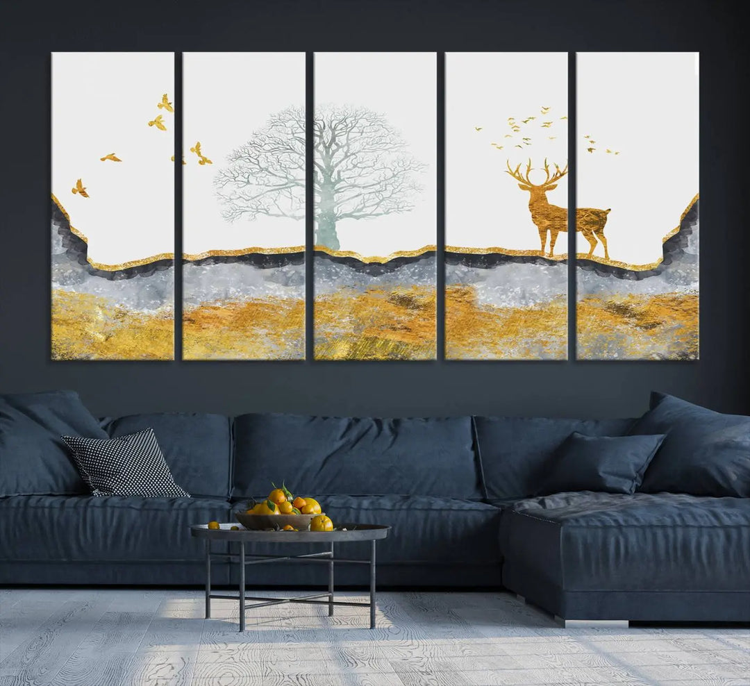 The dark gray wall is adorned with a triptych featuring a tree, birds, and a stag. This piece, titled "Artistic Deer Painting Wall Art Canvas Print Animal Wall Art Deer Art Print," is crafted as gallery-wrapped art from museum-quality polycotton and features a UV-protective coating to preserve its vibrant display.