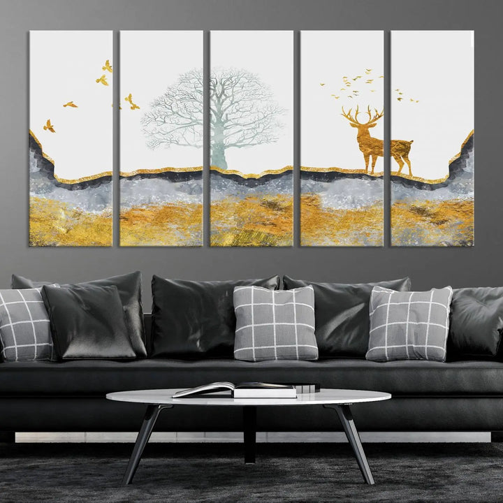 The dark gray wall is adorned with a triptych featuring a tree, birds, and a stag. This piece, titled "Artistic Deer Painting Wall Art Canvas Print Animal Wall Art Deer Art Print," is crafted as gallery-wrapped art from museum-quality polycotton and features a UV-protective coating to preserve its vibrant display.