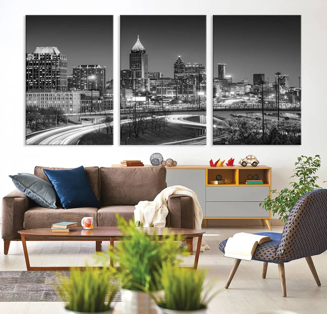 The living room is highlighted by an Atlanta Black and White Wall Art Cityscape Canvas Print that complements the black-and-white cityscape triptych on the wall, bringing an urban decor vibe to the space.