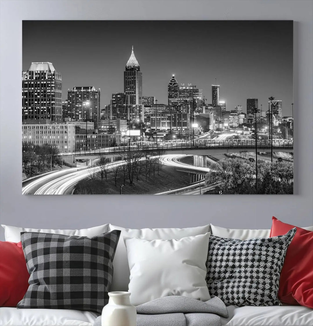 The living room is highlighted by an Atlanta Black and White Wall Art Cityscape Canvas Print that complements the black-and-white cityscape triptych on the wall, bringing an urban decor vibe to the space.