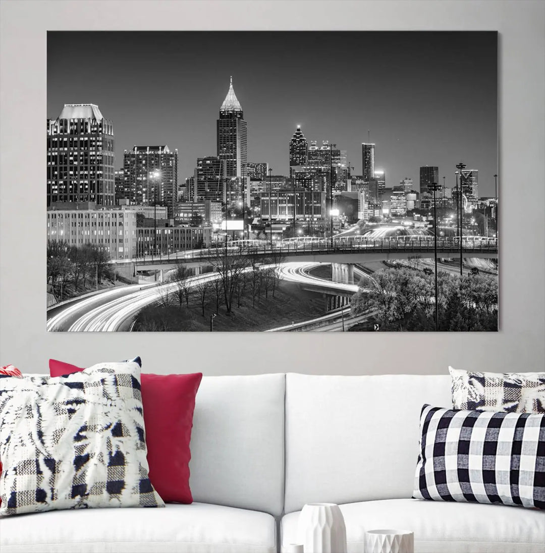 The living room is highlighted by an Atlanta Black and White Wall Art Cityscape Canvas Print that complements the black-and-white cityscape triptych on the wall, bringing an urban decor vibe to the space.