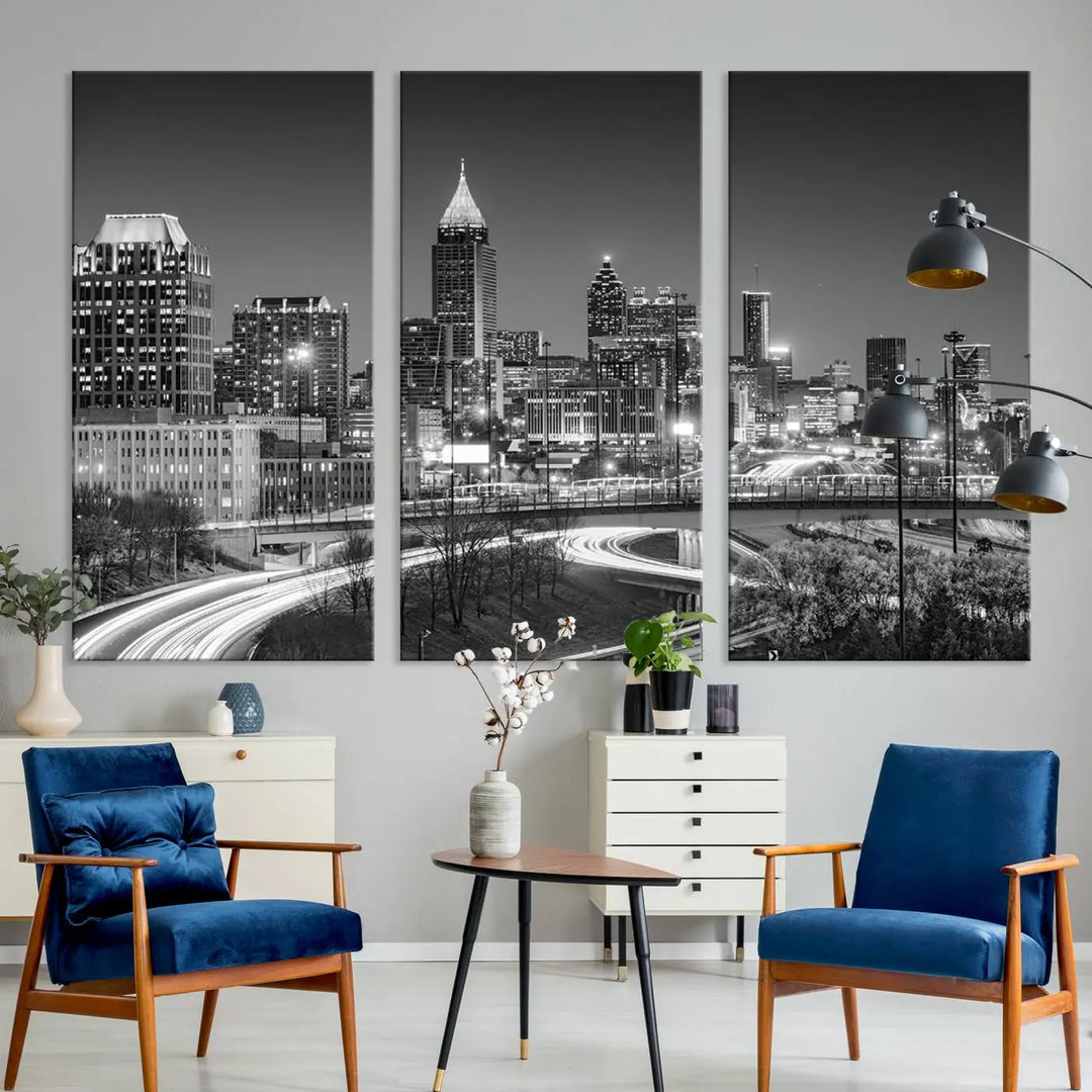 The living room is highlighted by an Atlanta Black and White Wall Art Cityscape Canvas Print that complements the black-and-white cityscape triptych on the wall, bringing an urban decor vibe to the space.