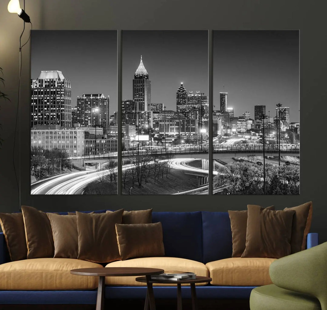 The living room is highlighted by an Atlanta Black and White Wall Art Cityscape Canvas Print that complements the black-and-white cityscape triptych on the wall, bringing an urban decor vibe to the space.