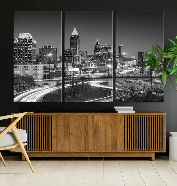 The living room is highlighted by an Atlanta Black and White Wall Art Cityscape Canvas Print that complements the black-and-white cityscape triptych on the wall, bringing an urban decor vibe to the space.