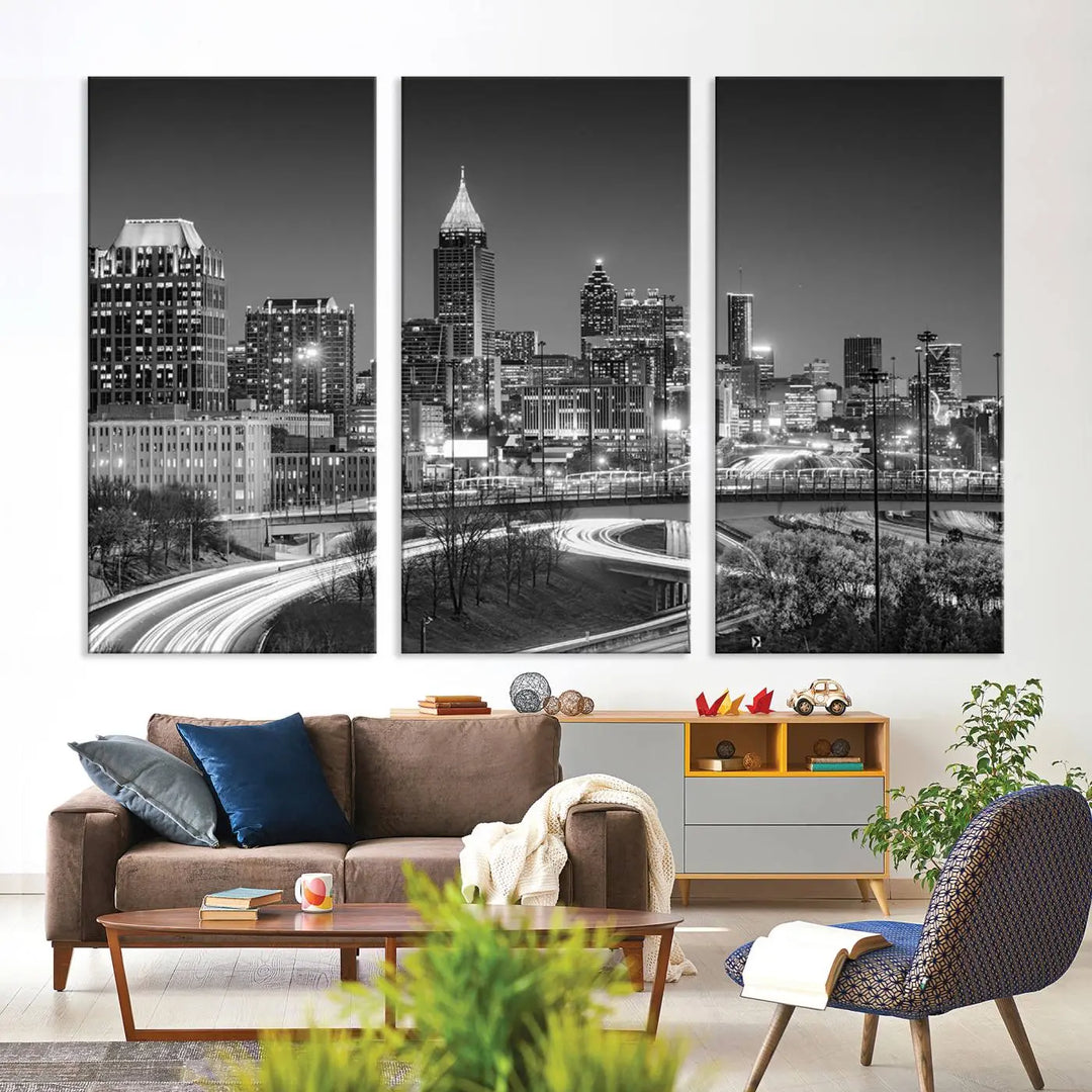 The living room is highlighted by an Atlanta Black and White Wall Art Cityscape Canvas Print that complements the black-and-white cityscape triptych on the wall, bringing an urban decor vibe to the space.