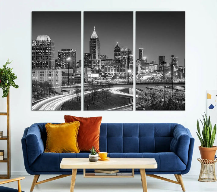 The living room is highlighted by an Atlanta Black and White Wall Art Cityscape Canvas Print that complements the black-and-white cityscape triptych on the wall, bringing an urban decor vibe to the space.