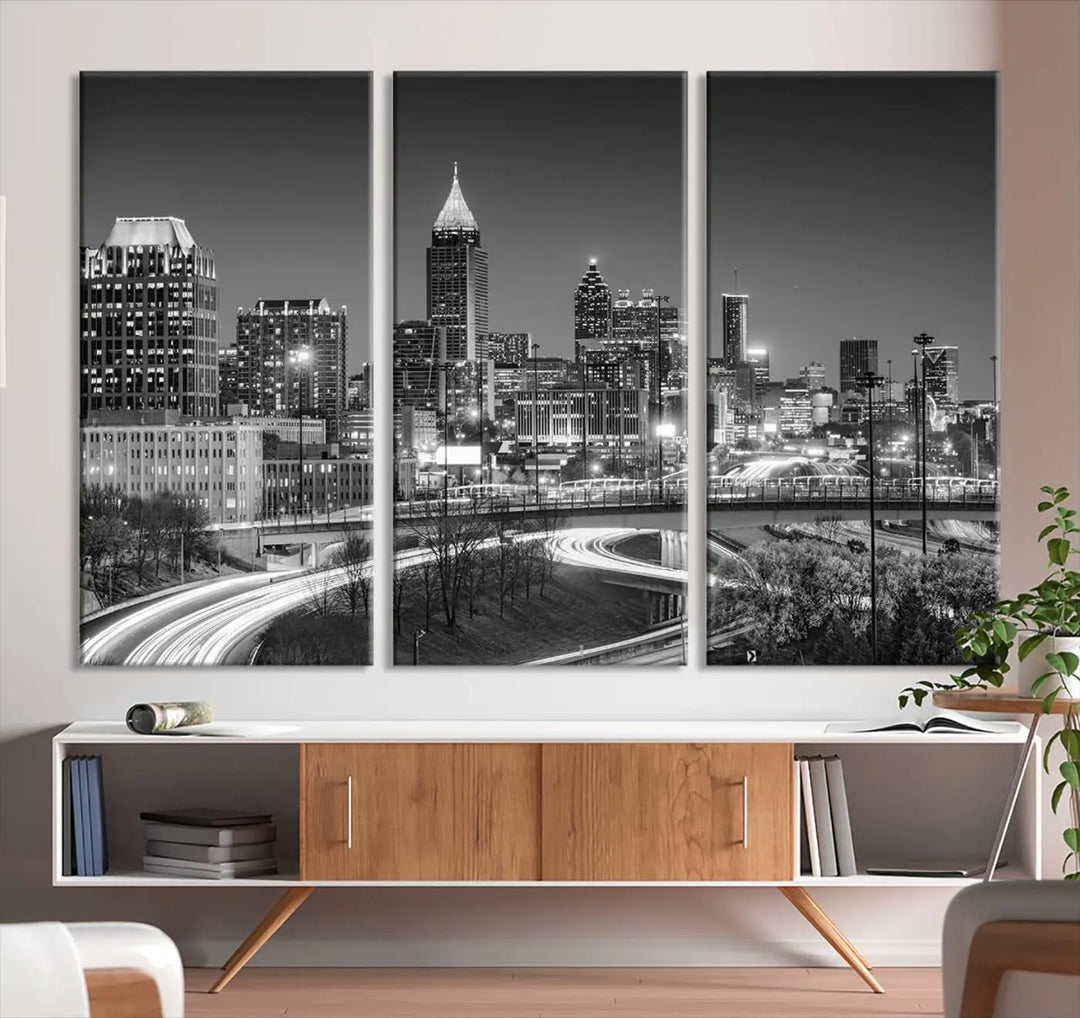 The living room is highlighted by an Atlanta Black and White Wall Art Cityscape Canvas Print that complements the black-and-white cityscape triptych on the wall, bringing an urban decor vibe to the space.