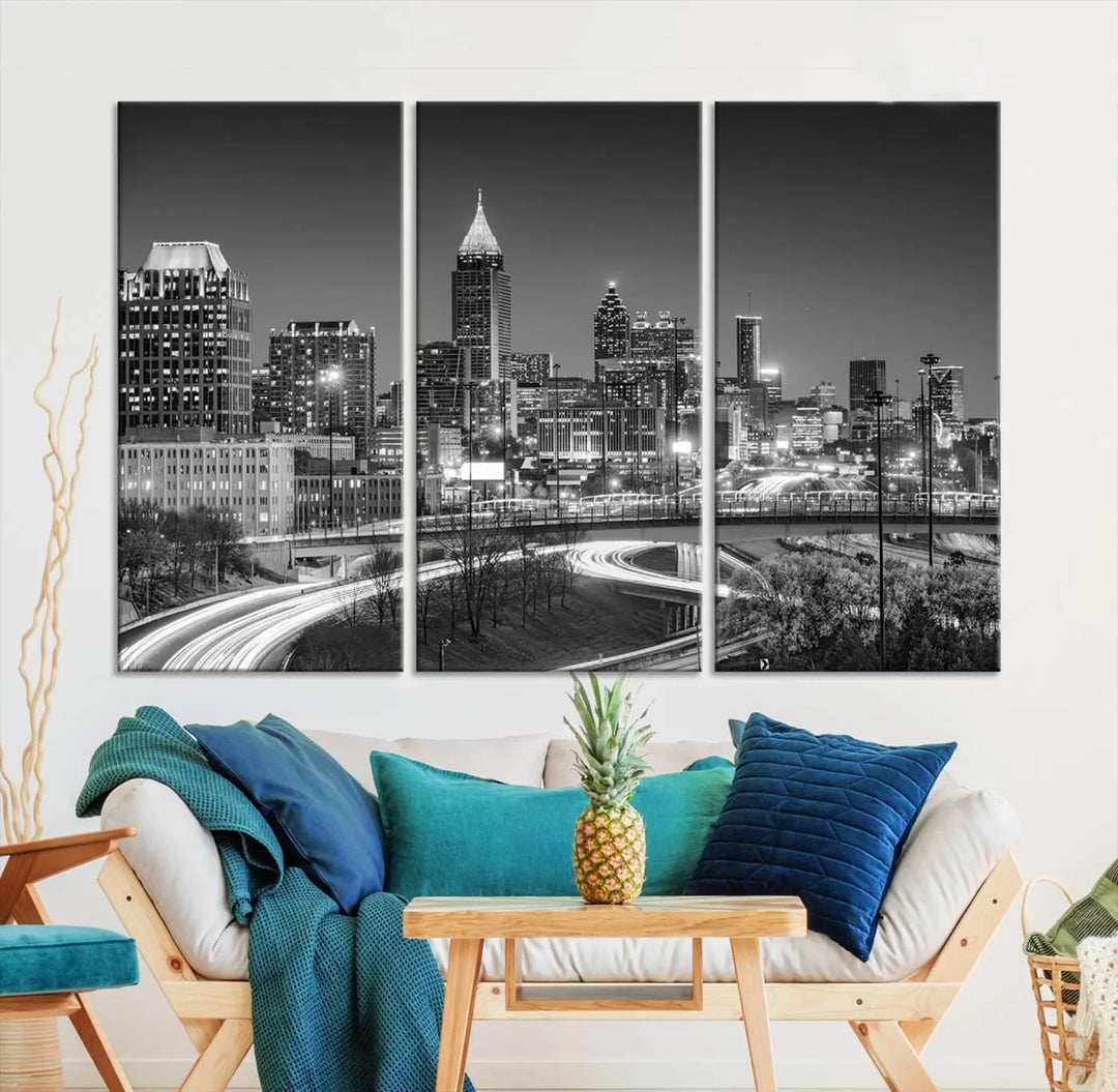 The living room is highlighted by an Atlanta Black and White Wall Art Cityscape Canvas Print that complements the black-and-white cityscape triptych on the wall, bringing an urban decor vibe to the space.