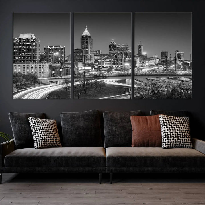 The living room is highlighted by an Atlanta Black and White Wall Art Cityscape Canvas Print that complements the black-and-white cityscape triptych on the wall, bringing an urban decor vibe to the space.