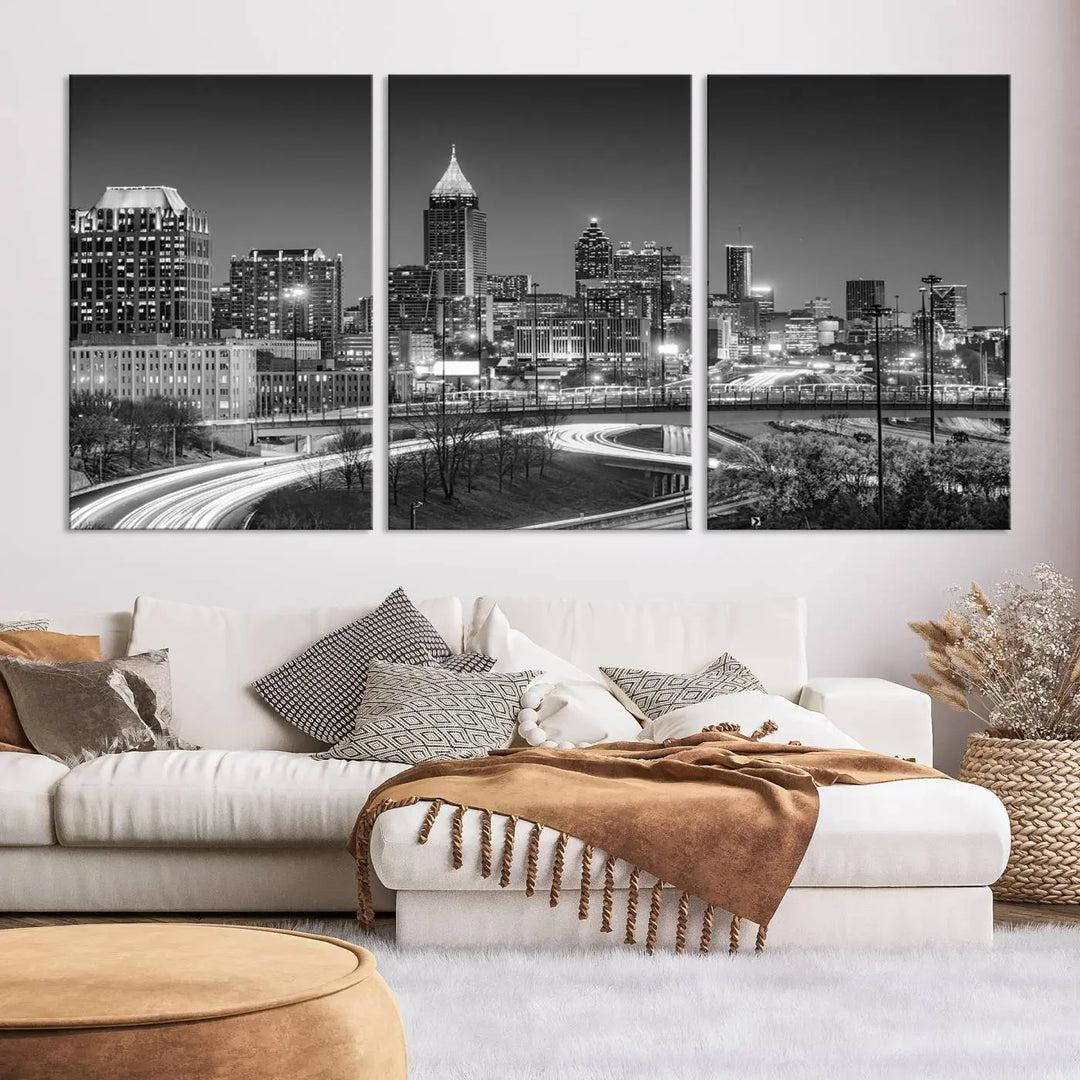 The living room is highlighted by an Atlanta Black and White Wall Art Cityscape Canvas Print that complements the black-and-white cityscape triptych on the wall, bringing an urban decor vibe to the space.