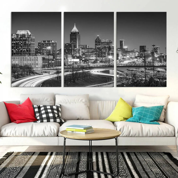 The living room is highlighted by an Atlanta Black and White Wall Art Cityscape Canvas Print that complements the black-and-white cityscape triptych on the wall, bringing an urban decor vibe to the space.