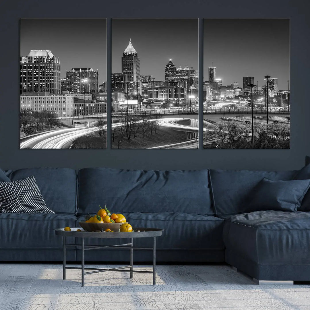 The living room is highlighted by an Atlanta Black and White Wall Art Cityscape Canvas Print that complements the black-and-white cityscape triptych on the wall, bringing an urban decor vibe to the space.