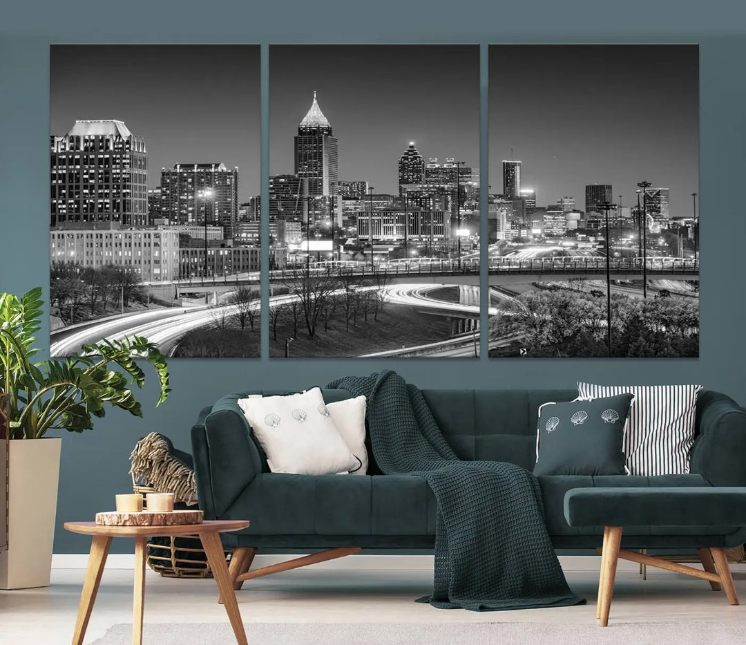 The living room is highlighted by an Atlanta Black and White Wall Art Cityscape Canvas Print that complements the black-and-white cityscape triptych on the wall, bringing an urban decor vibe to the space.