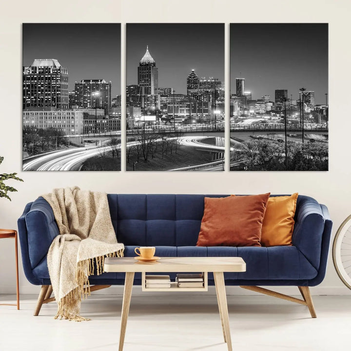 The living room is highlighted by an Atlanta Black and White Wall Art Cityscape Canvas Print that complements the black-and-white cityscape triptych on the wall, bringing an urban decor vibe to the space.