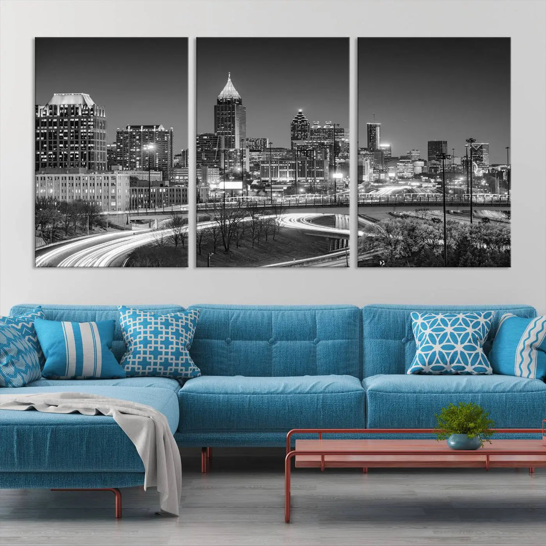 The living room is highlighted by an Atlanta Black and White Wall Art Cityscape Canvas Print that complements the black-and-white cityscape triptych on the wall, bringing an urban decor vibe to the space.