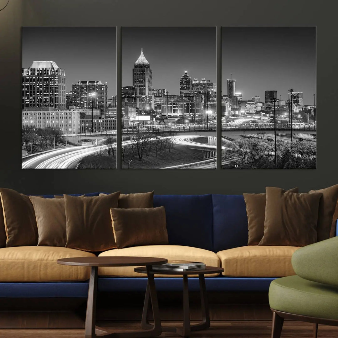 The living room is highlighted by an Atlanta Black and White Wall Art Cityscape Canvas Print that complements the black-and-white cityscape triptych on the wall, bringing an urban decor vibe to the space.