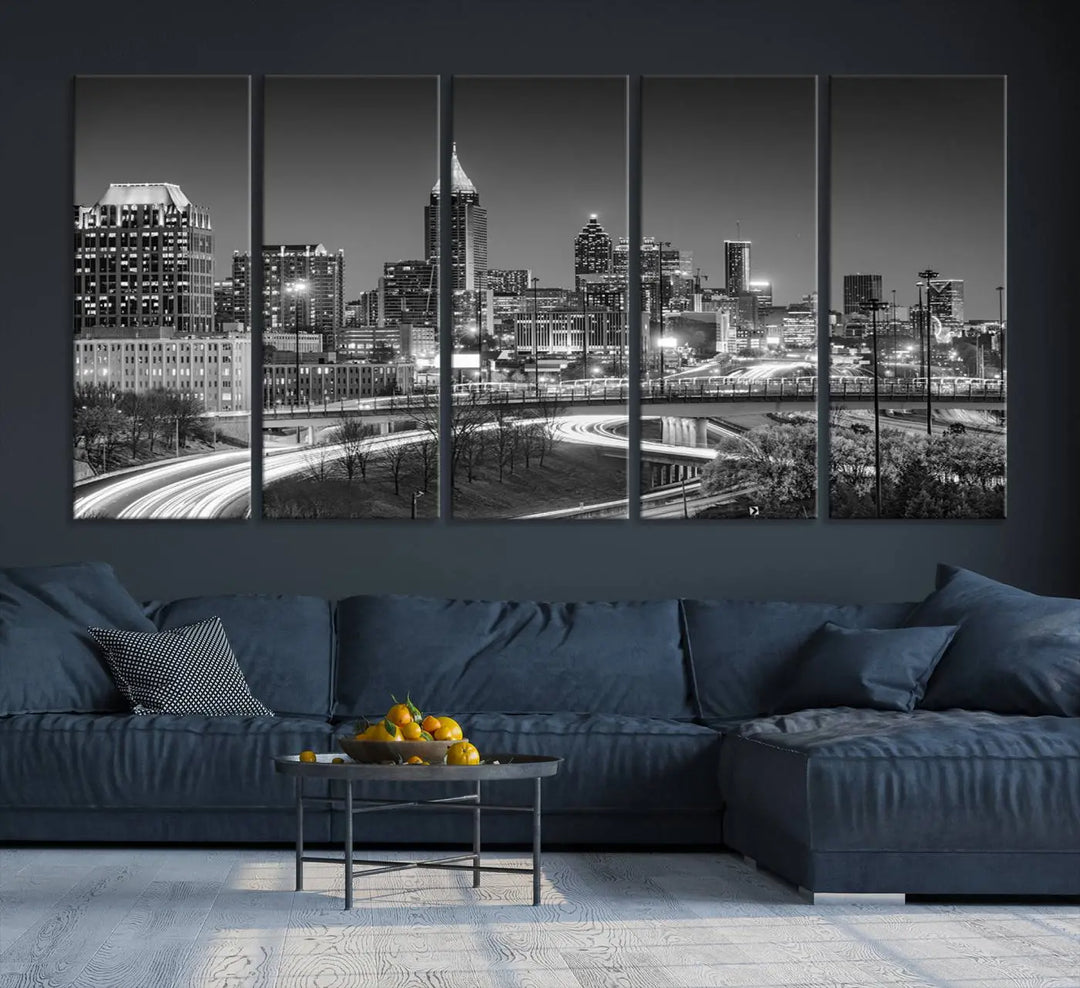 The living room is highlighted by an Atlanta Black and White Wall Art Cityscape Canvas Print that complements the black-and-white cityscape triptych on the wall, bringing an urban decor vibe to the space.