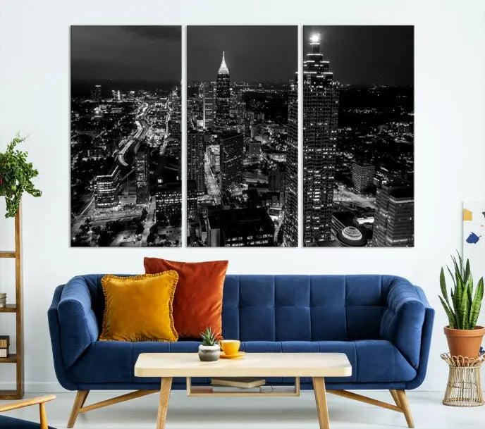 The contemporary living room features the "Atlanta Building Skyline Black and White Wall Art Cityscape Canvas Print" on the wall, designed as a gallery-wrapped museum-quality canvas for lasting elegance.