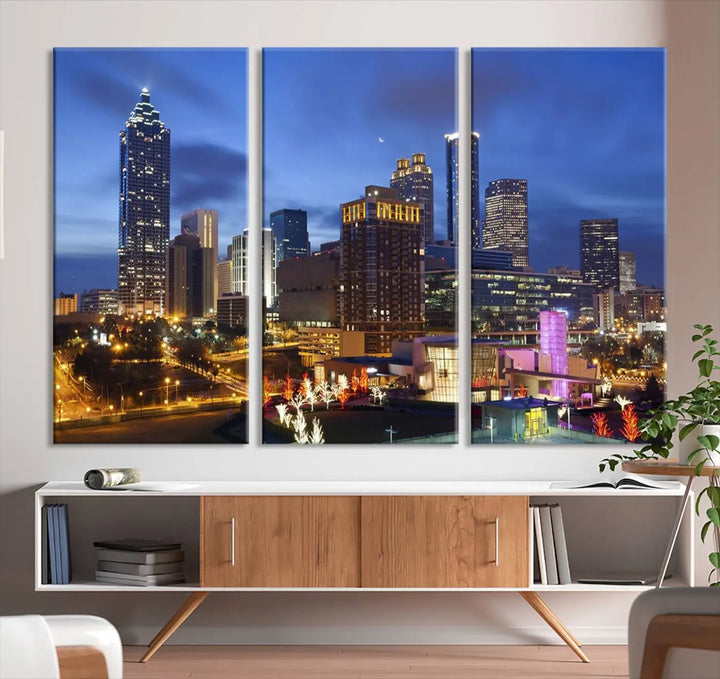 The Atlanta City Canvas Print adorns the wall, showcasing the cityscape of illuminated skyscrapers at dusk on a gallery-wrapped museum-quality canvas.