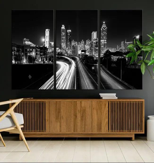 The room features an Atlanta City Lights Black and White Wall Art Cityscape Canvas Print on the wall, with the piece gallery wrapped on museum-quality canvas.