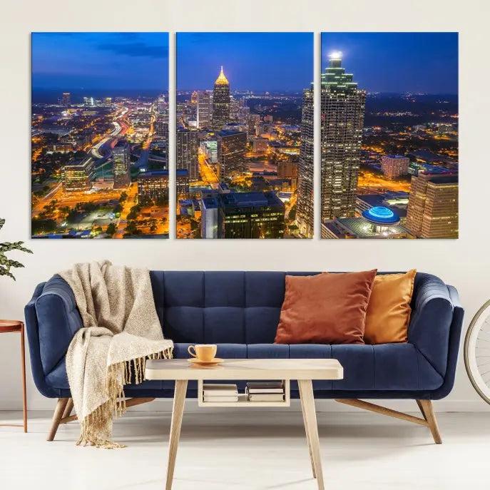 The room features three stunning pieces of the "Atlanta City Lights Cityscape View" wall art canvas prints, showcasing a lit-up city skyline adorned on the wall.