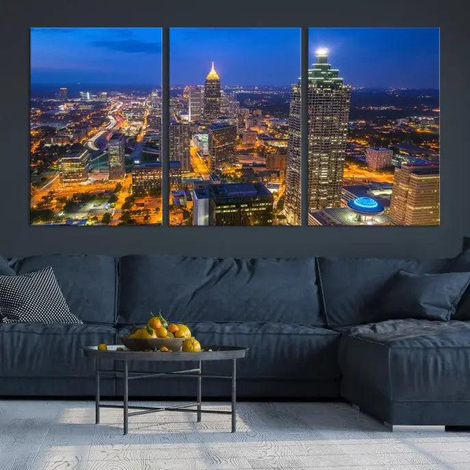 The room features three stunning pieces of the "Atlanta City Lights Cityscape View" wall art canvas prints, showcasing a lit-up city skyline adorned on the wall.