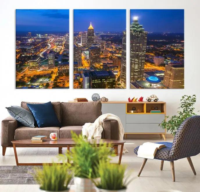 The room features three stunning pieces of the "Atlanta City Lights Cityscape View" wall art canvas prints, showcasing a lit-up city skyline adorned on the wall.