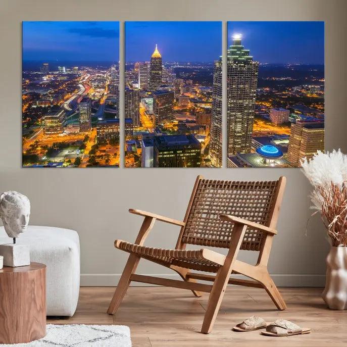 The room features three stunning pieces of the "Atlanta City Lights Cityscape View" wall art canvas prints, showcasing a lit-up city skyline adorned on the wall.