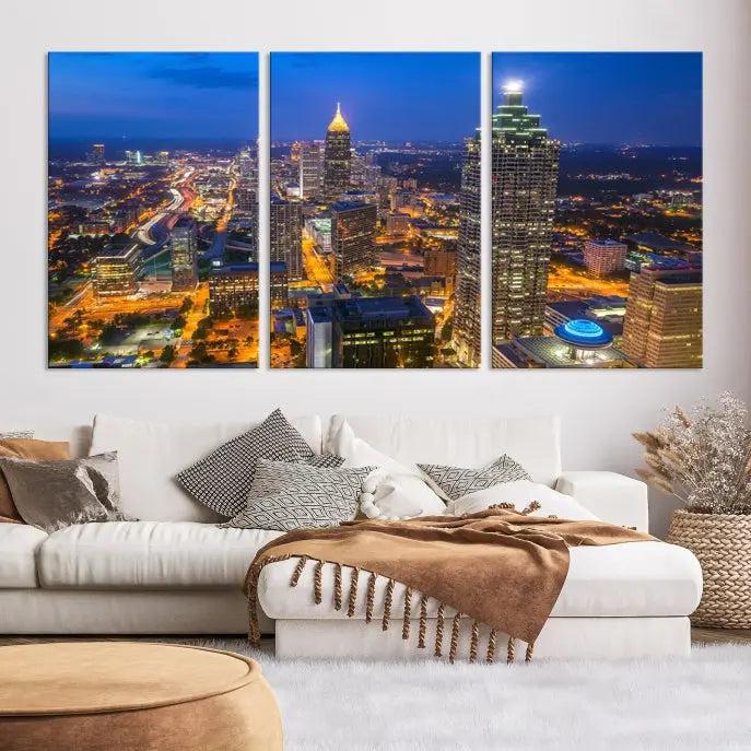 The room features three stunning pieces of the "Atlanta City Lights Cityscape View" wall art canvas prints, showcasing a lit-up city skyline adorned on the wall.