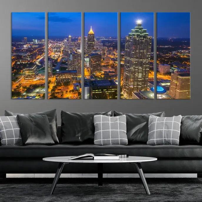 The room features three stunning pieces of the "Atlanta City Lights Cityscape View" wall art canvas prints, showcasing a lit-up city skyline adorned on the wall.